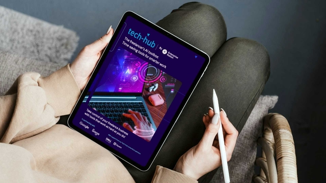 A woman with a tablet on her lap displaying the Tech Hub freelancer AI toolbox